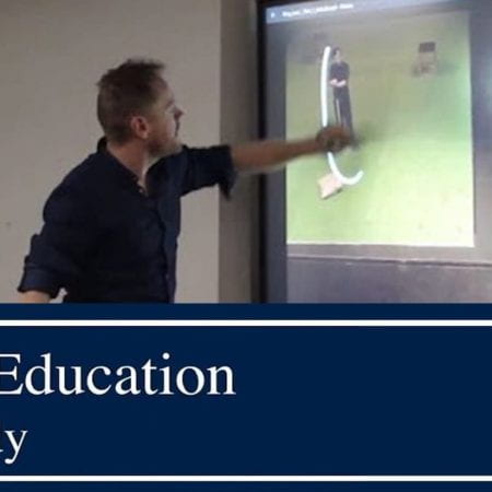 A picture of a man using an interactive touch screen. The title below read Digital Education Case Study.