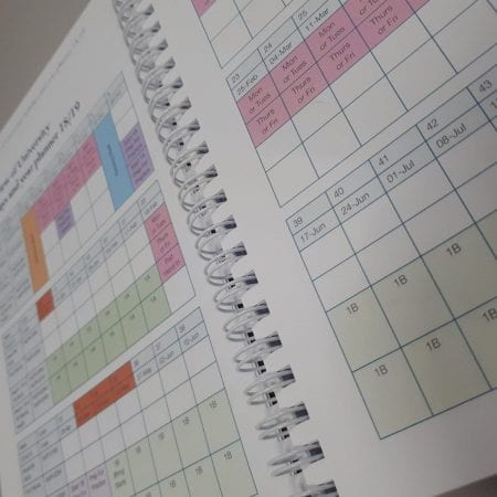 A close up of a book. Inside is a calendar/planner layout.