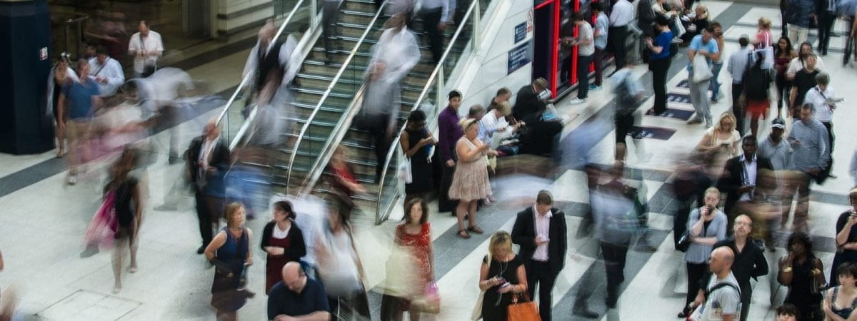A picture of a shopping centre. Most of the people are blurred.