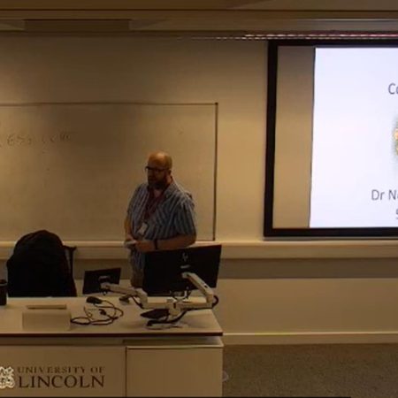 Image of person giving a lecture at a university