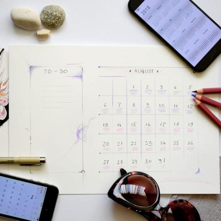 image showing a calendar planner and various other stationery and technology items.