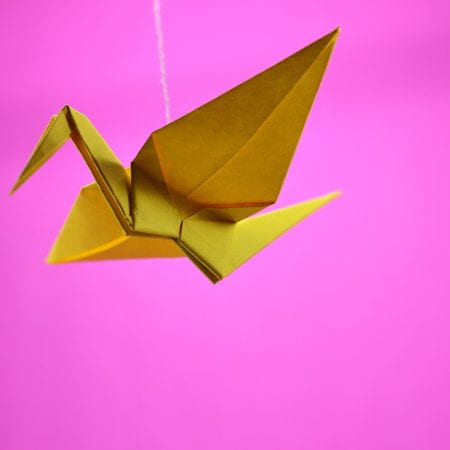 Photo showing a hanging Origami Crane paper ornament.